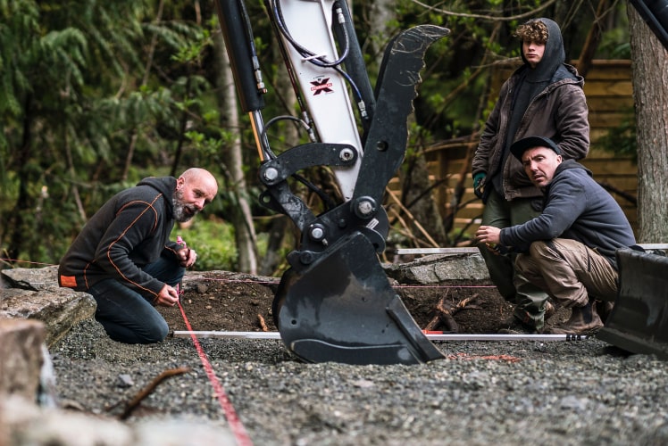 Excavator crew installing drainage