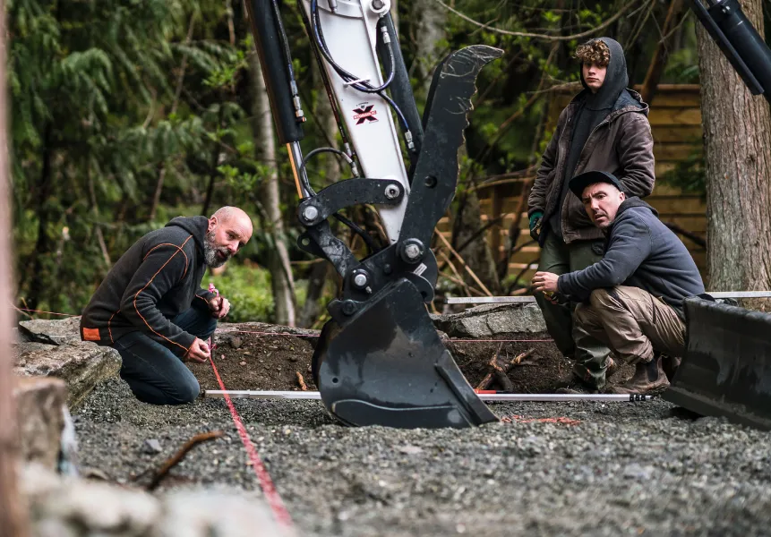 Landscape construction excavator crew