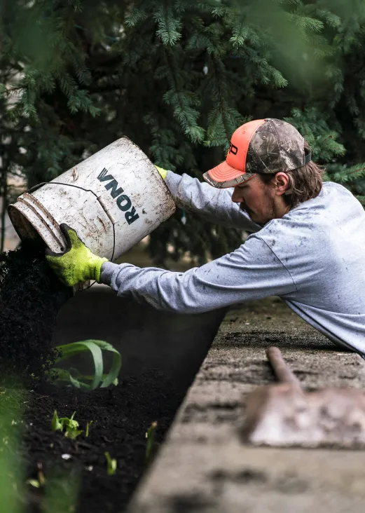 Worker applying soil amendment